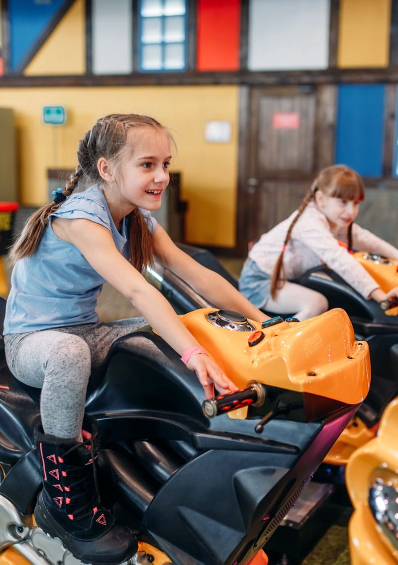 girls playing arcade game