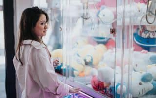 woman playing crane machine